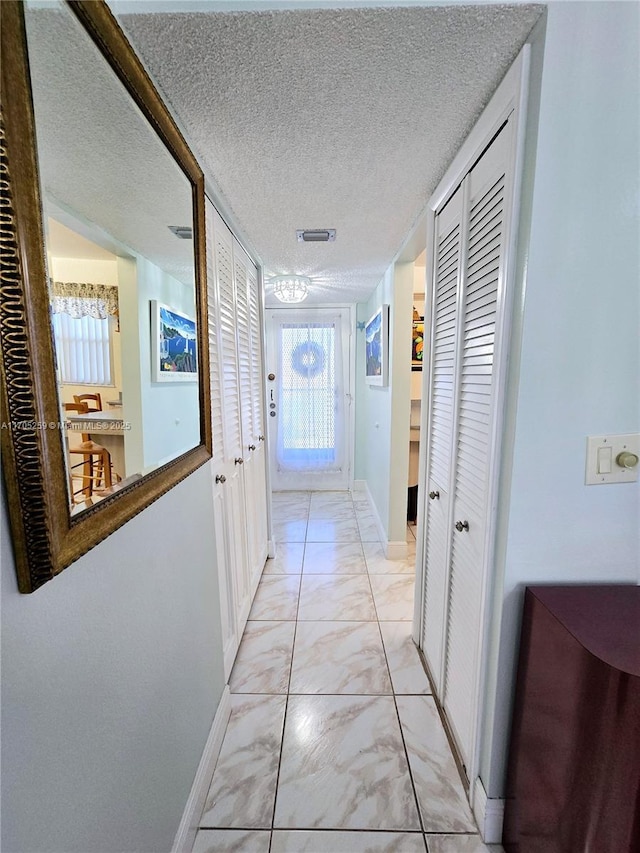 hallway featuring a textured ceiling