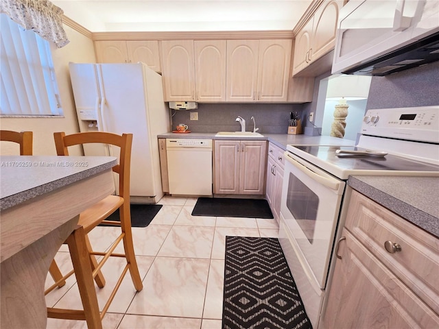 kitchen featuring light brown cabinetry, sink, white appliances, and light tile patterned flooring