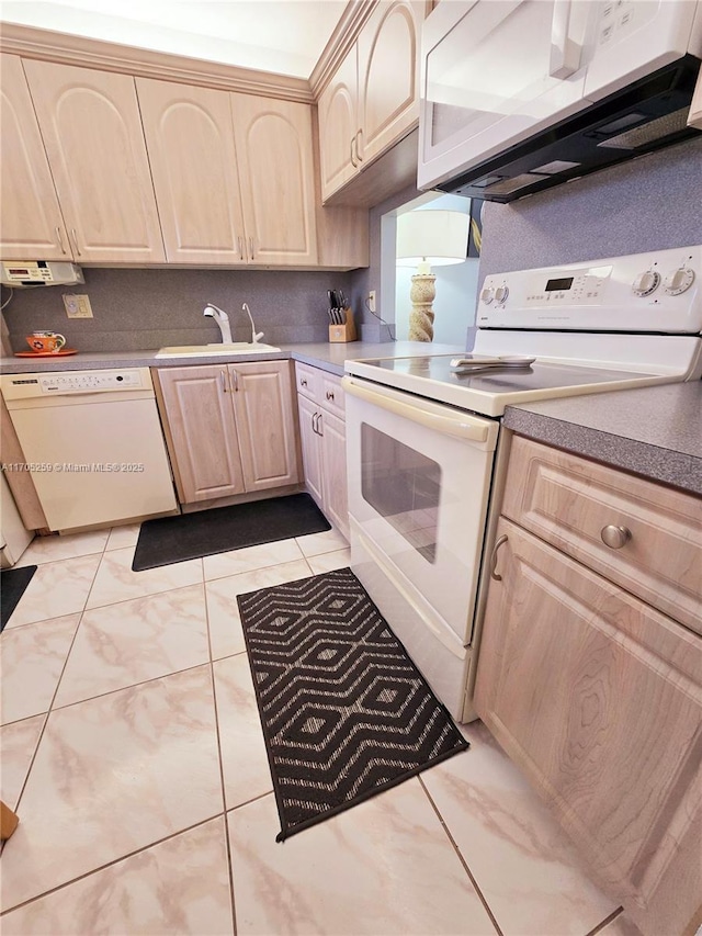 kitchen featuring sink, white appliances, and light brown cabinets