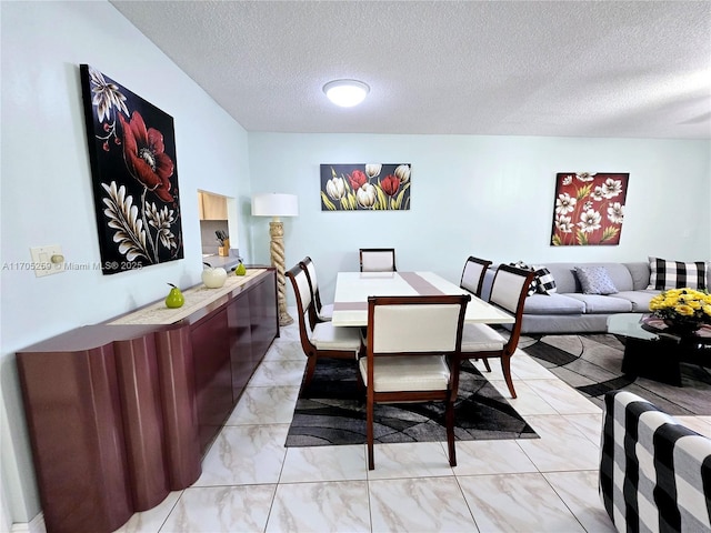 dining space featuring a textured ceiling