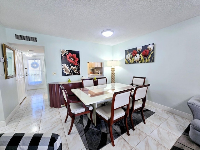 dining room featuring a textured ceiling