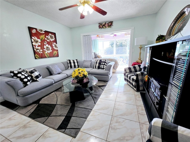 living room featuring ceiling fan and a textured ceiling