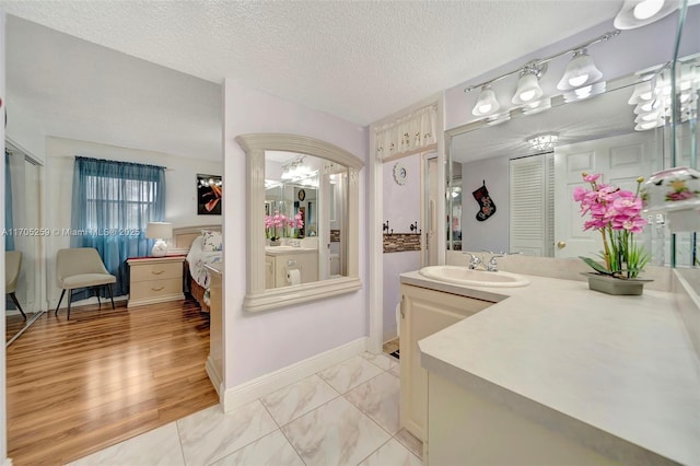 bathroom with a textured ceiling and vanity