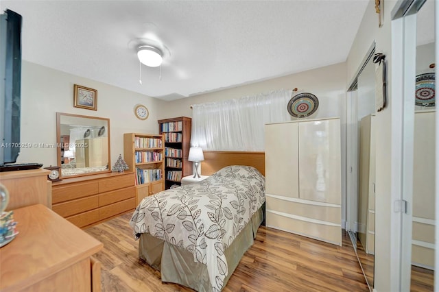 bedroom with ceiling fan and hardwood / wood-style floors