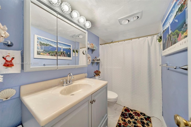 bathroom featuring toilet, vanity, and a shower with curtain