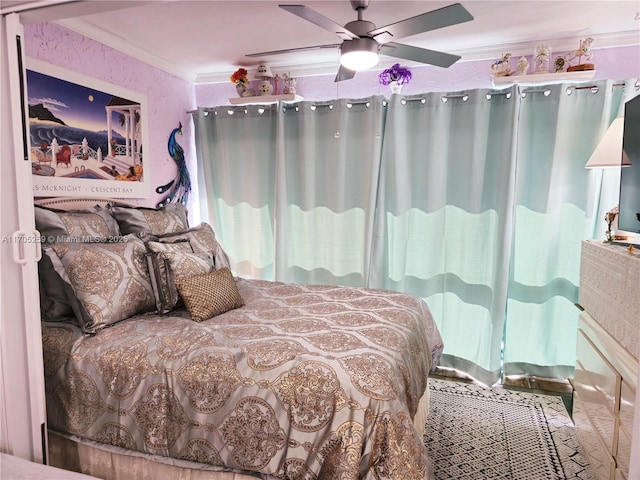 bedroom with ceiling fan and crown molding