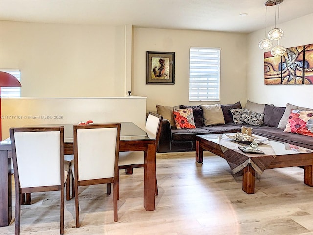 living room featuring breakfast area and light wood-type flooring