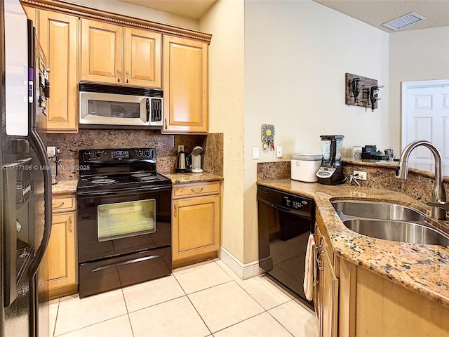 kitchen with light stone countertops, sink, tasteful backsplash, light tile patterned floors, and black appliances