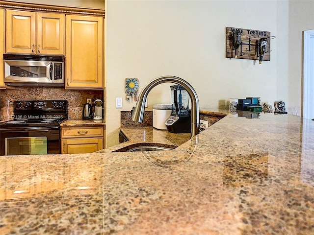 kitchen featuring black electric range, decorative backsplash, light stone countertops, and sink