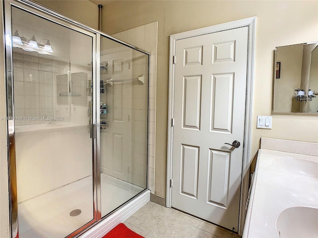 bathroom with tile patterned floors, vanity, and walk in shower