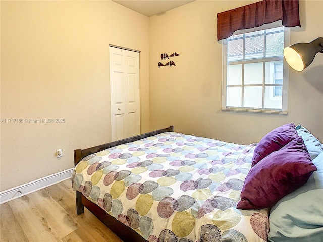 bedroom featuring light hardwood / wood-style floors and a closet