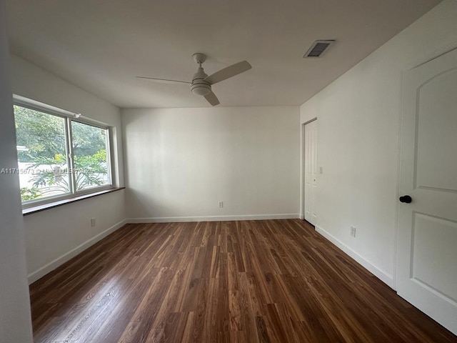 spare room featuring dark hardwood / wood-style floors and ceiling fan