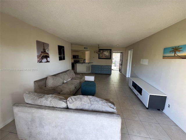 tiled living room featuring a textured ceiling