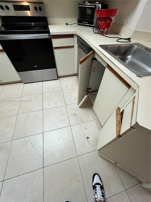 kitchen with appliances with stainless steel finishes, light tile patterned floors, and sink