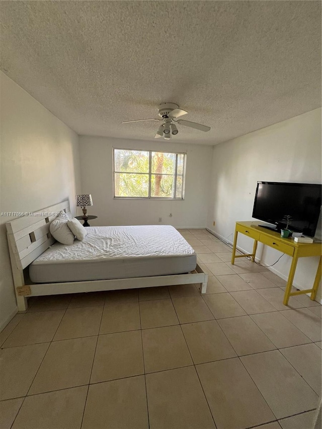 tiled bedroom featuring ceiling fan and a textured ceiling