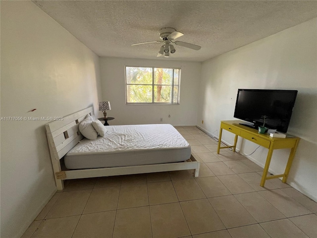 bedroom with ceiling fan and a textured ceiling