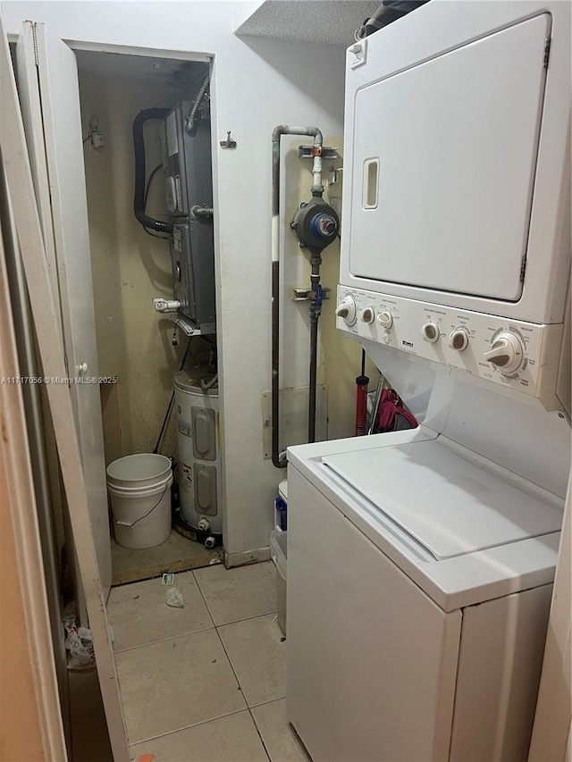 washroom with light tile patterned floors and stacked washer and clothes dryer