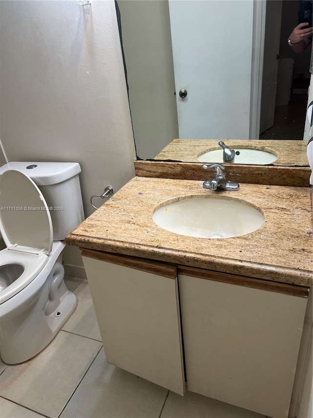 bathroom with tile patterned floors, vanity, and toilet