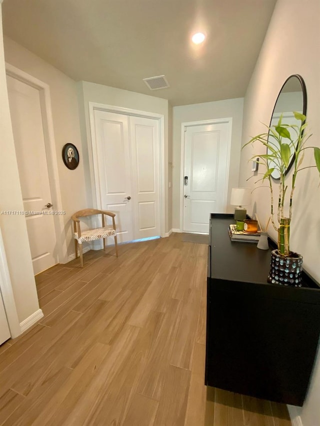 corridor featuring light hardwood / wood-style floors