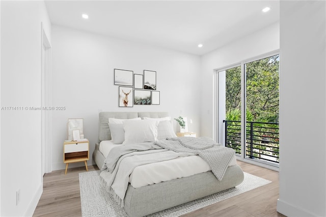 bedroom featuring access to exterior and light hardwood / wood-style flooring