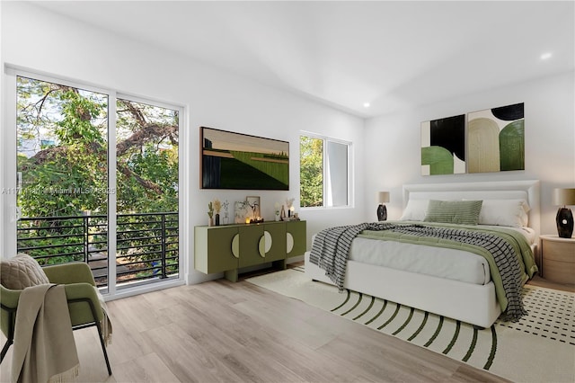 bedroom featuring access to outside and light hardwood / wood-style flooring