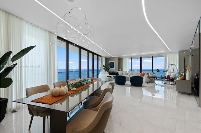 tiled living room featuring expansive windows and a water view