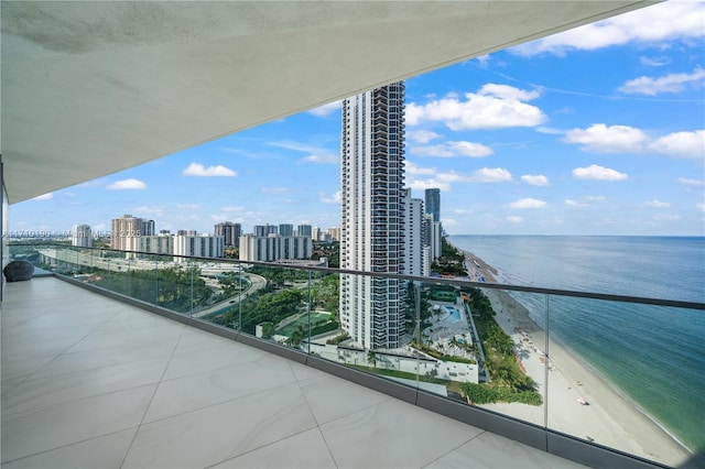 balcony featuring a water view and a view of the beach