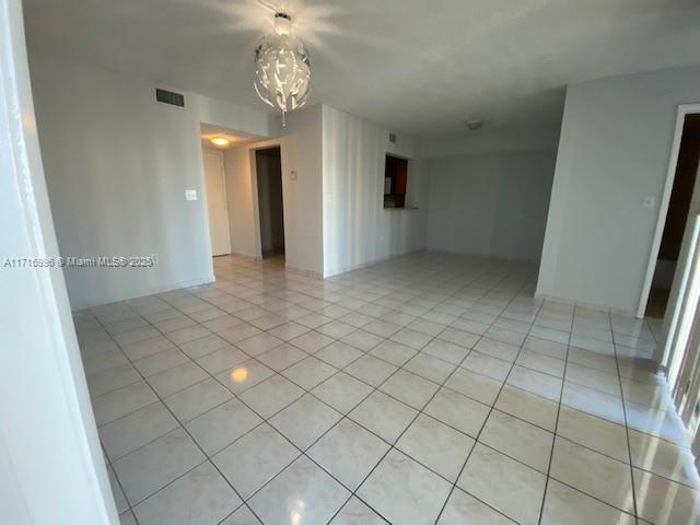 2055 SW 122nd Ave Unit 205, Miami, FL 33175 - spare room with visible vents, a chandelier, and light tile patterned floors