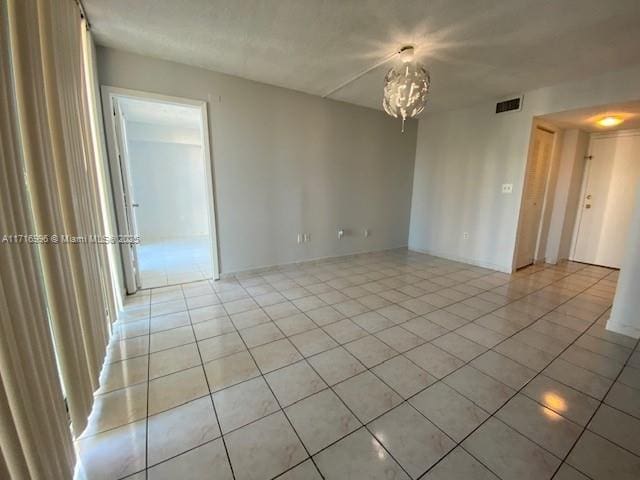 2055 SW 122nd Ave Unit 205, Miami, FL 33175 - spare room with visible vents, a notable chandelier, and light tile patterned floors