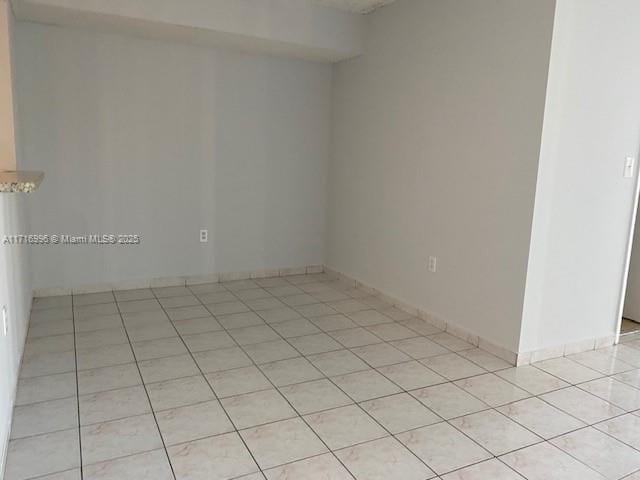 unfurnished room featuring light tile patterned floors