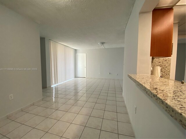 2055 SW 122nd Ave Unit 205, Miami, FL 33175 - empty room featuring a textured ceiling and light tile patterned floors