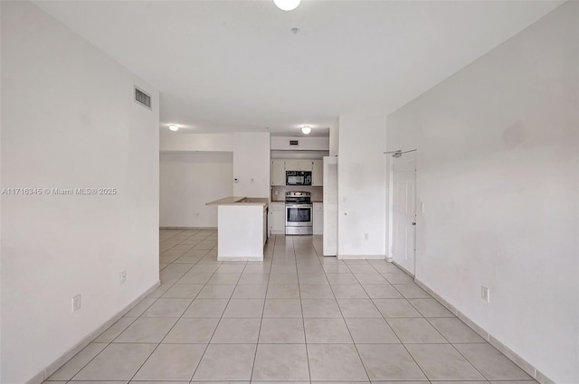 unfurnished living room featuring light tile patterned flooring