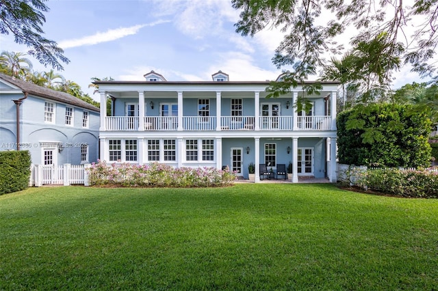 rear view of property with a patio area, fence, french doors, and a yard