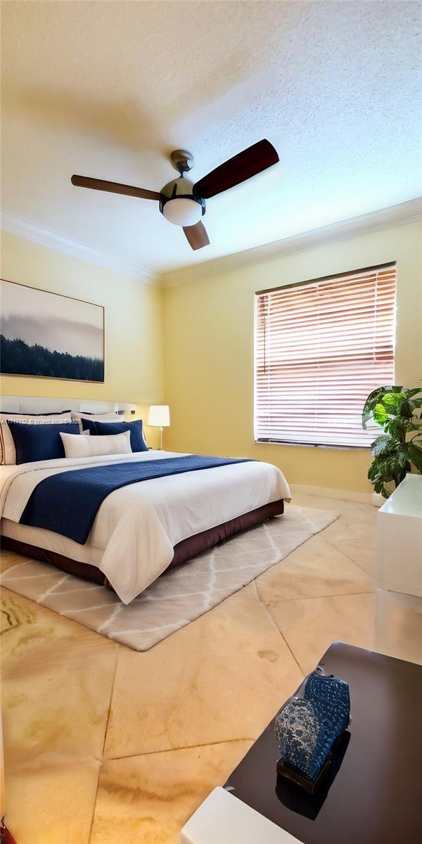 tiled bedroom with ceiling fan, crown molding, and a textured ceiling