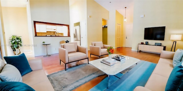 living room featuring hardwood / wood-style floors and high vaulted ceiling