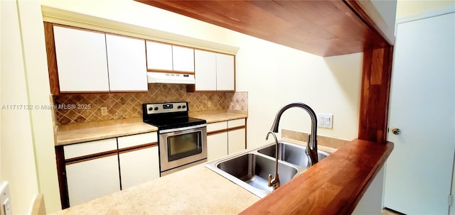 kitchen featuring electric range, decorative backsplash, white cabinetry, and sink