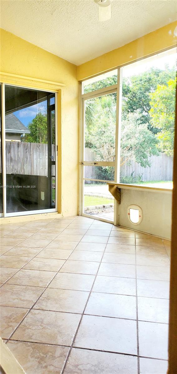 unfurnished sunroom featuring lofted ceiling