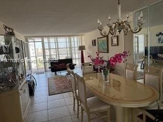 dining room featuring light tile patterned floors, a chandelier, and a wall of windows