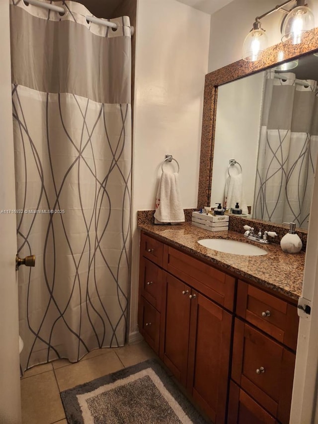 bathroom with tile patterned floors and vanity