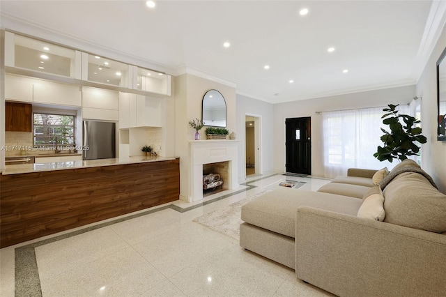 living area with recessed lighting, light speckled floor, a fireplace, baseboards, and crown molding