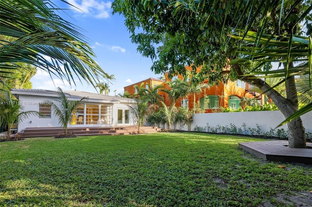 view of yard featuring a wooden deck and french doors
