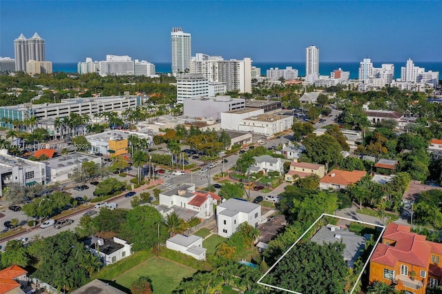 drone / aerial view with a city view and a water view