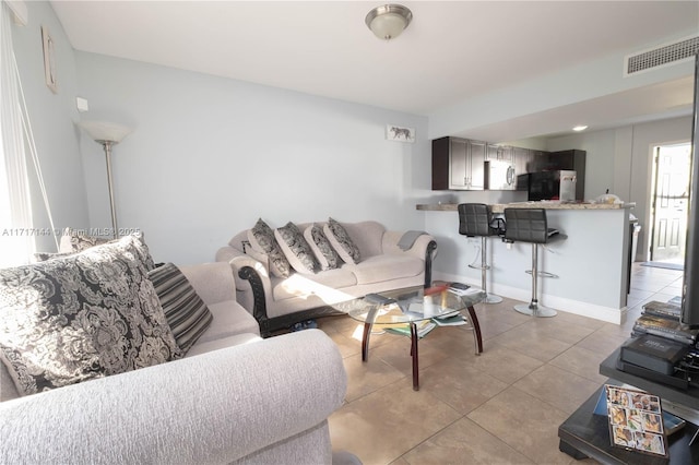 living room with light tile patterned floors