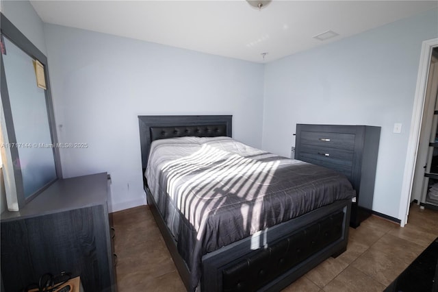 bedroom with dark tile patterned floors