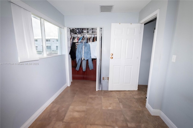 hallway with tile patterned floors