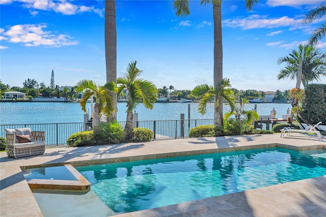 view of swimming pool featuring a water view and a patio