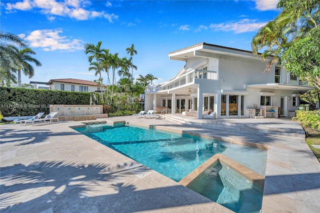 view of swimming pool featuring an in ground hot tub and a patio area