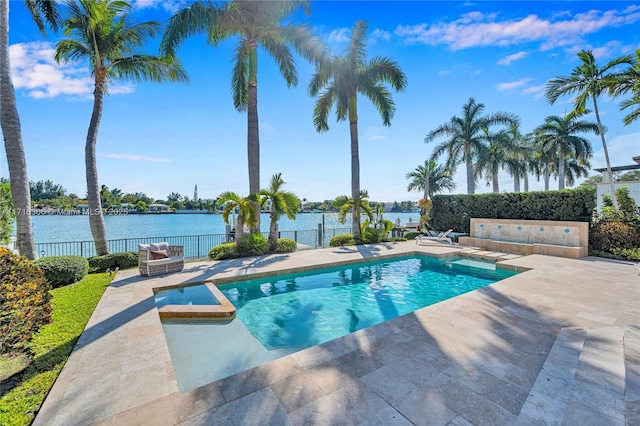 view of pool with a water view and a patio area