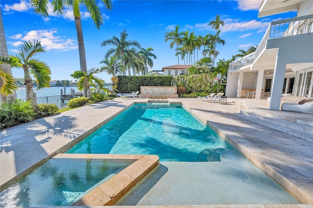 view of swimming pool with a patio area and an in ground hot tub