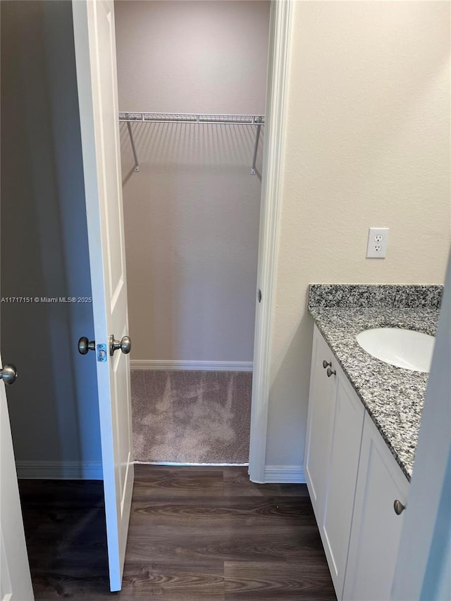 bathroom with hardwood / wood-style flooring and vanity